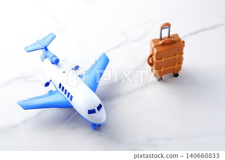 Airplane and suitcase - Image of a plane waiting to take off and a suitcase (carry-on case) departing for a trip Airplane and suitcase - Image of a plane waiting to take off and a suitcase (carry-on case) departing for a trip 140660833