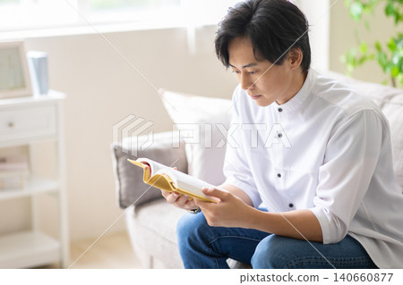 A man reading a book 140660877