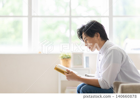 A man reading a book 140660878