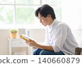 A man reading a book 140660879