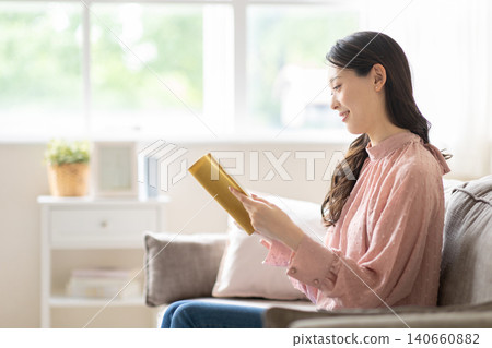 A woman reading a book 140660882