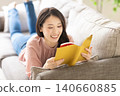 A woman reading a book 140660885