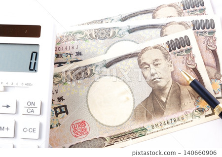 A 10,000 yen bill and a calculator - A 10,000 yen bill and a calculator placed on a table. A 10,000 yen bill and a calculator - A 10,000 yen bill and a calculator placed on a table. 140660906