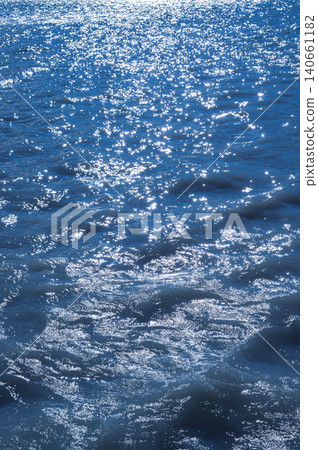 Patagonia blue water with bright sun sparkle and gentle wave texture 140661182