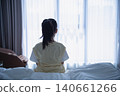 Child Sitting on Bed Looking Out Window in Cozy Bedroom with Natural Light, Calm Atmosphere, and Comfortable Environment, Indoor Residential Scene 140661266