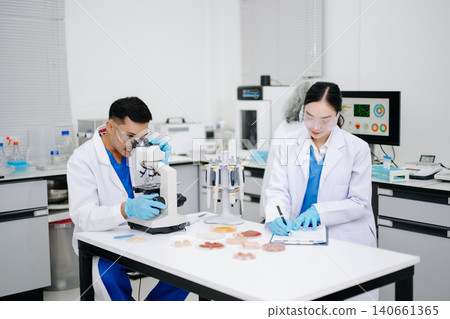 Team of Diverse Asian Scientists Conducting Research in Modern Laboratory 140661365