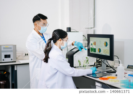 Professional scientists performing laboratory research with microscopes, biotechnology testing, medical innovation and healthcare science in a modern lab. 140661371