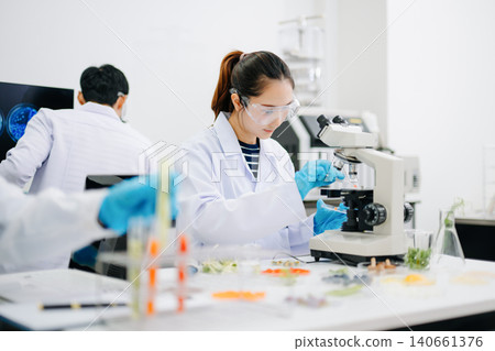 Professional scientists performing laboratory research with microscopes, biotechnology testing, medical innovation and healthcare science in a modern lab. Professional scientists performing laboratory research with microscopes, biotechnology testing, medical innovation and healthcare science in a modern lab. 140661376
