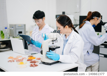 Professional scientists performing laboratory research with microscopes, biotechnology testing, medical innovation and healthcare science in a modern lab. 140661377