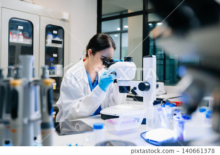 Modern medical research laboratory. female scientist working with micro pipettes analyzing biochemical samples, advanced science chemical laboratory for medicine. 140661378