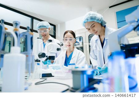 Team scientist or medical technician working, having a medical discuss meeting with an Asian senior female scientist supervisor Team scientist or medical technician working, having a medical discuss meeting with an Asian senior female scientist supervisor 140661417