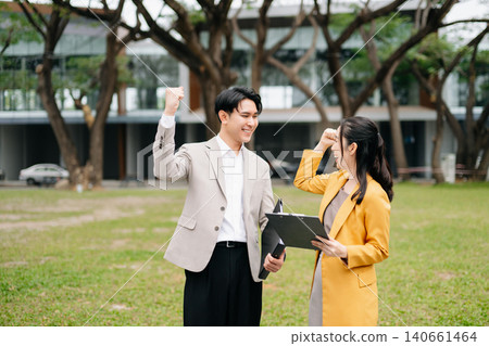 Asian business team discussing strategy and planning outdoors, corporate meeting, teamwork, leadership and professional collaboration Asian business team discussing strategy and planning outdoors, corporate meeting, teamwork, leadership and professional collaboration 140661464