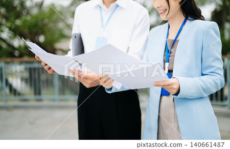 Business professionals reviewing reports and discussing strategy in modern corporate environment, teamwork, partnership, management and office Business professionals reviewing reports and discussing strategy in modern corporate environment, teamwork, partnership, management and office 140661487