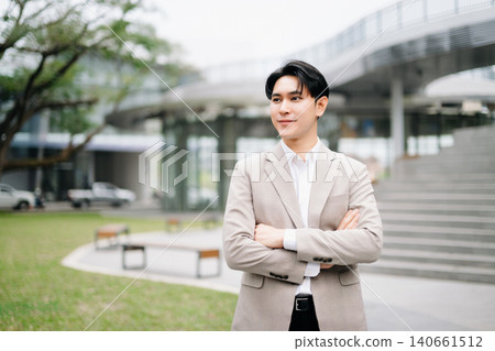 Confident Asian businessman giving thumbs up outside modern office building, success, approval, leadership, startup growth Confident Asian businessman giving thumbs up outside modern office building, success, approval, leadership, startup growth 140661512