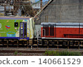 A KiHa 120 series diesel railcar being moved to a new location. 140661529