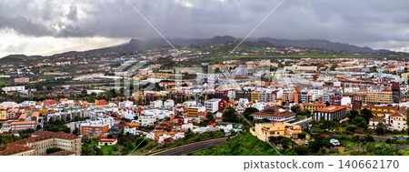 Panoramic view over the historic city of San Cristobal de La Laguna under a cloudy sky in Tenerife, Spain. Panoramic view over the historic city of San Cristobal de La Laguna under a cloudy sky in Tenerife, Spain. 140662170