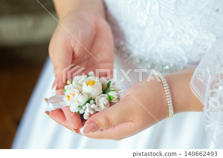 Bride's hands with a bouquet for the groom. place for text Bride's hands with a bouquet for the groom. place for text 140662493