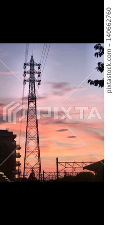 A transmission tower standing in the evening light A transmission tower standing in the evening light 140662760