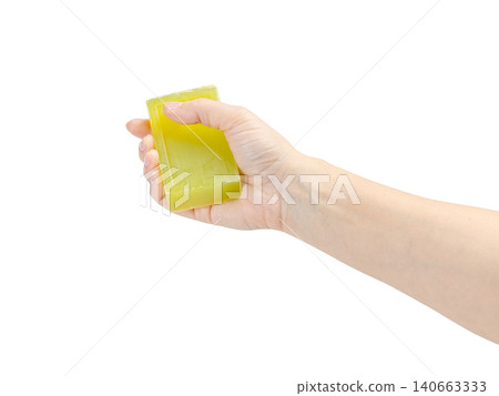 Woman holding soap in her hand on the white background. Woman holding soap in her hand on the white background. 140663333