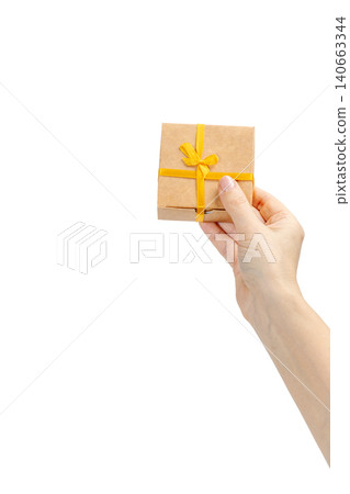 Woman's hand holding a gift box on the white background. Woman's hand holding a gift box on the white background. 140663344