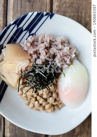 Natto rice with sixteen grains, topped with a soft-boiled egg and pickled young ginger. Natto rice with sixteen grains, topped with a soft-boiled egg and pickled young ginger. 140663397