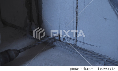 Faint Concrete Nook Glowing With Blue Light. Shadowed Corner With Exposed Pipes And Subtle Illumination. Incomplete And Dimly Lit Corner Featuring Conduits And Soft Blue Ambient Glow 140663512