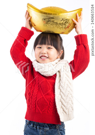 Happy Asian girl holding a large gold ingot (Yuanbao) wishing for wealth and prosperity in Chinese New Year.The Chinese characters above: "Attract Wealth and Treasure" Happy Asian girl holding a large gold ingot (Yuanbao) wishing for wealth and prosperity in Chinese New Year.The Chinese characters above: "Attract Wealth and Treasure" 140663584