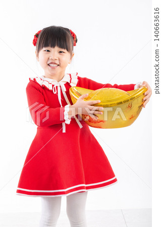 Happy Asian girl holding a large gold ingot (Yuanbao) wishing for wealth and prosperity in Chinese New Year.The Chinese characters above: "Attract Wealth and Treasure" 140663616