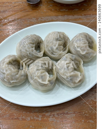 Korean dumplings filled with a mix of savory ingredients like ground meat, tofu, and vegetables. Mandu can be steamed, boiled, or pan-fried, making it a versatile and delicious snack or meal. Korean dumplings filled with a mix of savory ingredients like ground meat, tofu, and vegetables. Mandu can be steamed, boiled, or pan-fried, making it a versatile and delicious snack or meal. 140663699