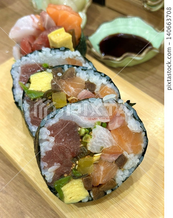 An assortment of fresh sushi, artfully arranged with a variety of toppings and vibrant colors. This traditional Japanese dish combines vinegared rice, seafood, and vegetables for an experience. An assortment of fresh sushi, artfully arranged with a variety of toppings and vibrant colors. This traditional Japanese dish combines vinegared rice, seafood, and vegetables for an experience. 140663708