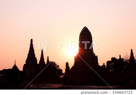 Sunset scene in Wat Chaiwatthanaram, Thailand. Picturesque scene with old temple, stupa and tree, Thailand, Southeast Asia. Topic of vacation, travel, trip, cruise, tour. Photo toned in yellow color 140663725