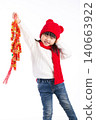 Cute Asian girl in red dress holding firecracker decorations and smiling, Chinese New Year celebration concept. 140663922