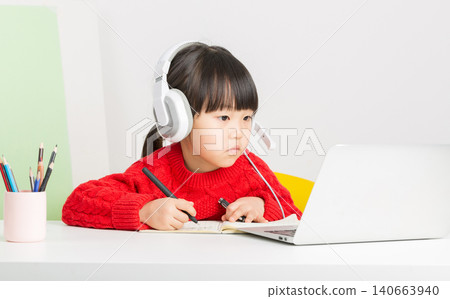 Asian child using laptop and headset for online class at home, e-learning and digital education concept. Asian child using laptop and headset for online class at home, e-learning and digital education concept. 140663940
