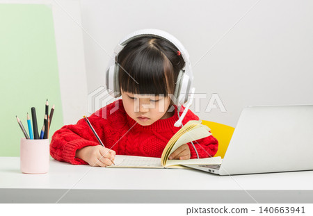 Asian child using laptop and headset for online class at home, e-learning and digital education concept. Asian child using laptop and headset for online class at home, e-learning and digital education concept. 140663941