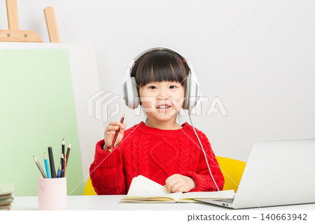 Asian child using laptop and headset for online class at home, e-learning and digital education concept. 140663942