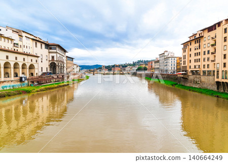 Florence in winter: A view of the town along the Arno River from the Ponte Vecchio. Florence in winter: A view of the town along the Arno River from the Ponte Vecchio. 140664249