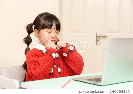asian little girl doing eye exercises to relax eyes during online learning at home, healthy study habits concept asian little girl doing eye exercises to relax eyes during online learning at home, healthy study habits concept 140664335