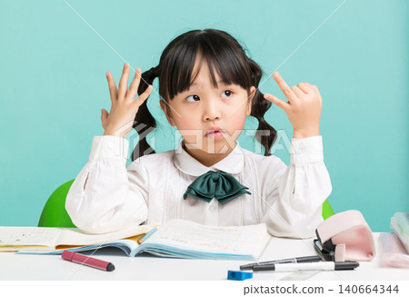 Asian schoolgirl counting on fingers while studying at desk, thinking and math learning concept, education and problem solving Asian schoolgirl counting on fingers while studying at desk, thinking and math learning concept, education and problem solving 140664344