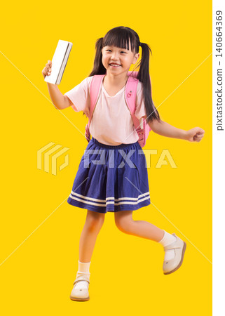 Cheerful young Asian girl in school uniform holding white notebook and wearing pink backpack while stepping forward Cheerful young Asian girl in school uniform holding white notebook and wearing pink backpack while stepping forward 140664369