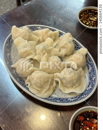 Korean dumplings filled with a mix of savory ingredients like ground meat, tofu, and vegetables. Mandu can be steamed, boiled, or pan-fried, making it a versatile and delicious snack or meal. 140664530