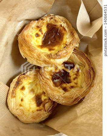 Golden egg tart with a flaky, buttery crust and a rich, creamy custard center. A deliciously satisfying treat for dessert or a light snack, blending texture and flavor perfectly. 140664531