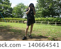 A tall woman relaxing in the park 140664541