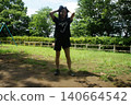 A tall woman relaxing in the park 140664542