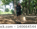 A tall woman relaxing in the park 140664544