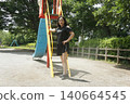 A tall woman relaxing in the park 140664545