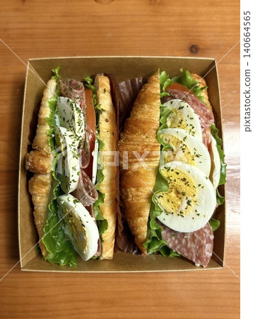 Flaky croissant sandwiches filled with fresh vegetables, deli meats, and creamy cheeses. A perfect balance of buttery layers and savory fillings for a satisfying meal or snack! Flaky croissant sandwiches filled with fresh vegetables, deli meats, and creamy cheeses. A perfect balance of buttery layers and savory fillings for a satisfying meal or snack! 140664565