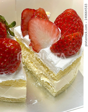 Strawberry cake with soft fluffy layers, topped with fresh strawberries and smooth cream, showcasing vibrant red fruit, delicate textures, and sweet inviting appearance in close-up detail Strawberry cake with soft fluffy layers, topped with fresh strawberries and smooth cream, showcasing vibrant red fruit, delicate textures, and sweet inviting appearance in close-up detail 140664583