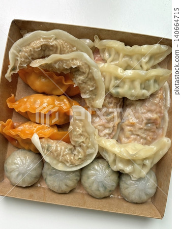Korean dumplings filled with a mix of savory ingredients like ground meat, tofu, and vegetables. Mandu can be steamed, boiled, or pan-fried, making it a versatile and delicious snack or meal. Korean dumplings filled with a mix of savory ingredients like ground meat, tofu, and vegetables. Mandu can be steamed, boiled, or pan-fried, making it a versatile and delicious snack or meal. 140664715