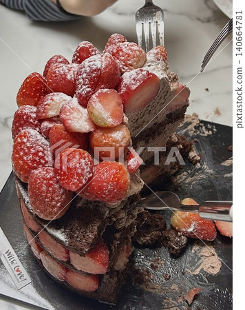 Strawberry cake with soft fluffy layers, topped with fresh strawberries and smooth cream, showcasing vibrant red fruit, delicate textures, and sweet inviting appearance in close-up detail Strawberry cake with soft fluffy layers, topped with fresh strawberries and smooth cream, showcasing vibrant red fruit, delicate textures, and sweet inviting appearance in close-up detail 140664781