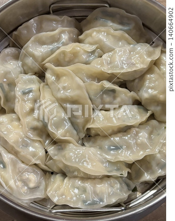 Korean dumplings filled with a mix of savory ingredients like ground meat, tofu, and vegetables. Mandu can be steamed, boiled, or pan-fried, making it a versatile and delicious snack or meal. Korean dumplings filled with a mix of savory ingredients like ground meat, tofu, and vegetables. Mandu can be steamed, boiled, or pan-fried, making it a versatile and delicious snack or meal. 140664902